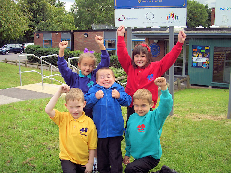 Children outside Tenacres School with their new colourful uniforms