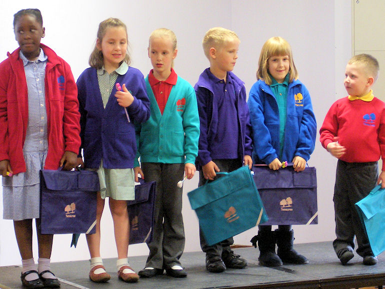 Children in different coloured uniform and school bags